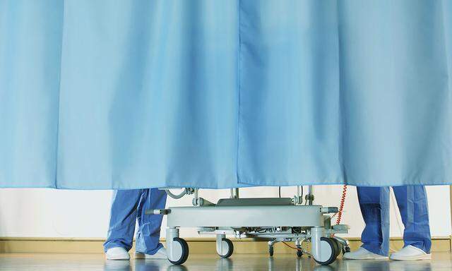Medical staff around patient's bed, curtains drawn, low section