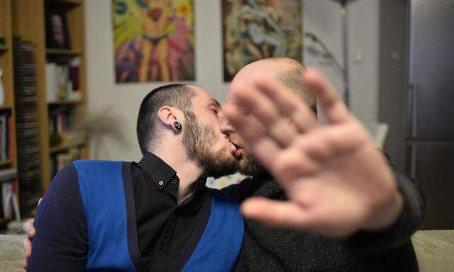 Gay couple Dusan Veselovsky (R), 39, and Libor Marko, 25, kiss in their apartment on the day of a referendum that aims to maintain a ban on same-sex marriage, in Bratislava