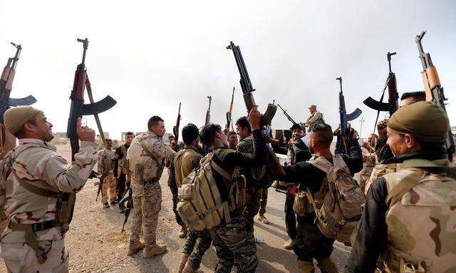 Members of Iraqi security forces celebrate after the liberation of Khalidiya village from Islamic State militants, south of Mosul, during an operation to attack Islamic State militants in Mosul