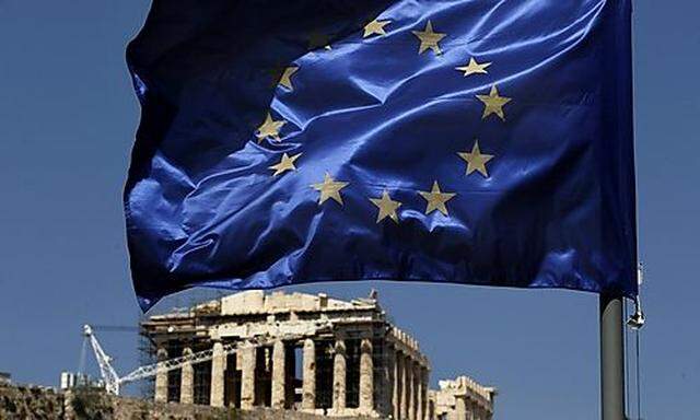 A European Union flag waves above the ancient Parthenon temple, at the Acropolis Hill, in Athens on M