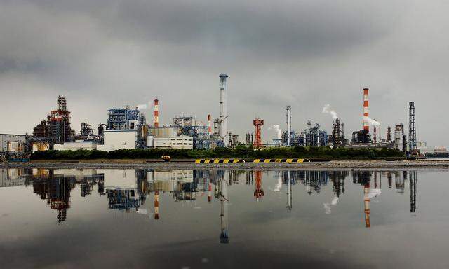 File photo of a petrochemical plant reflected in a puddle at an industrial complex in Kawasaki near Tokyo 