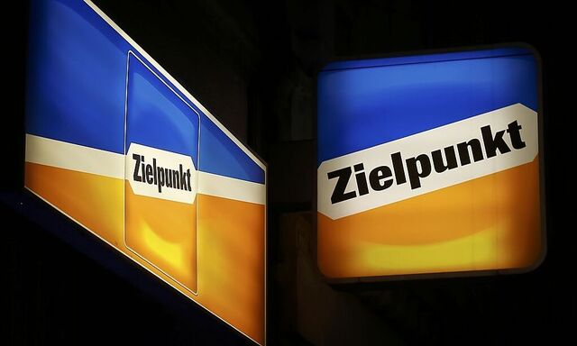 Logos of Austrian supermarket chain Zielpunkt are illuminated outside one of its stores in Vienna