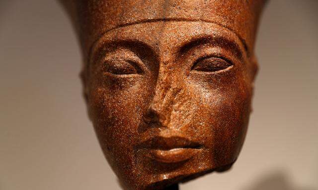 An Egyptian brown quartzite head of the God Amen is seen at Christie´s auction house prior to its´ sale in London
