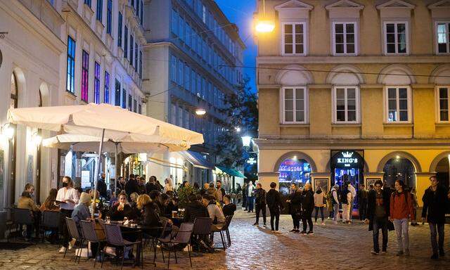 People enjoy an evening drink after Austria eases its COVID-19 restrictions