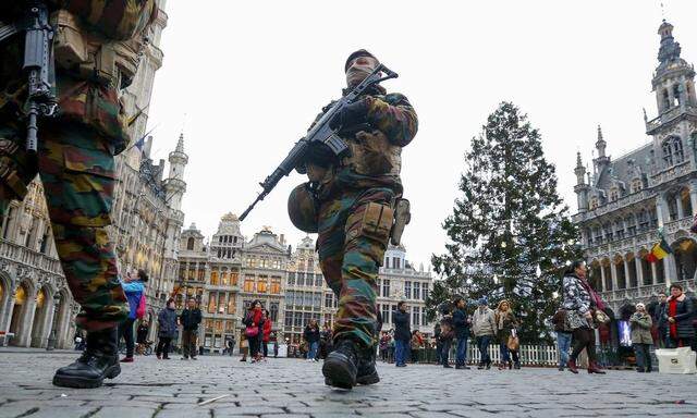 Belgian soldiers patrol along 'Winter Wonders', a Christmas market in central Brussels