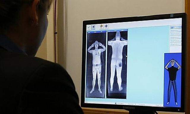 A security officer examines a computer screen showing a scan from a RapiScan full-body scanner, being