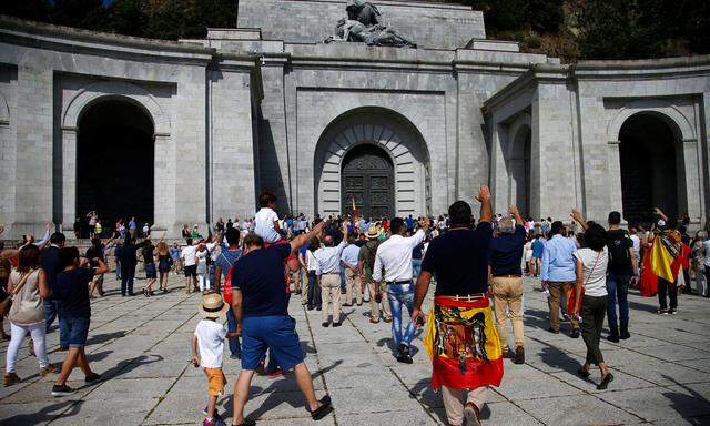 People attend a demonstration against plans to remove Franco from the Valle de los Caidos in San Lorenzo de El Escorial