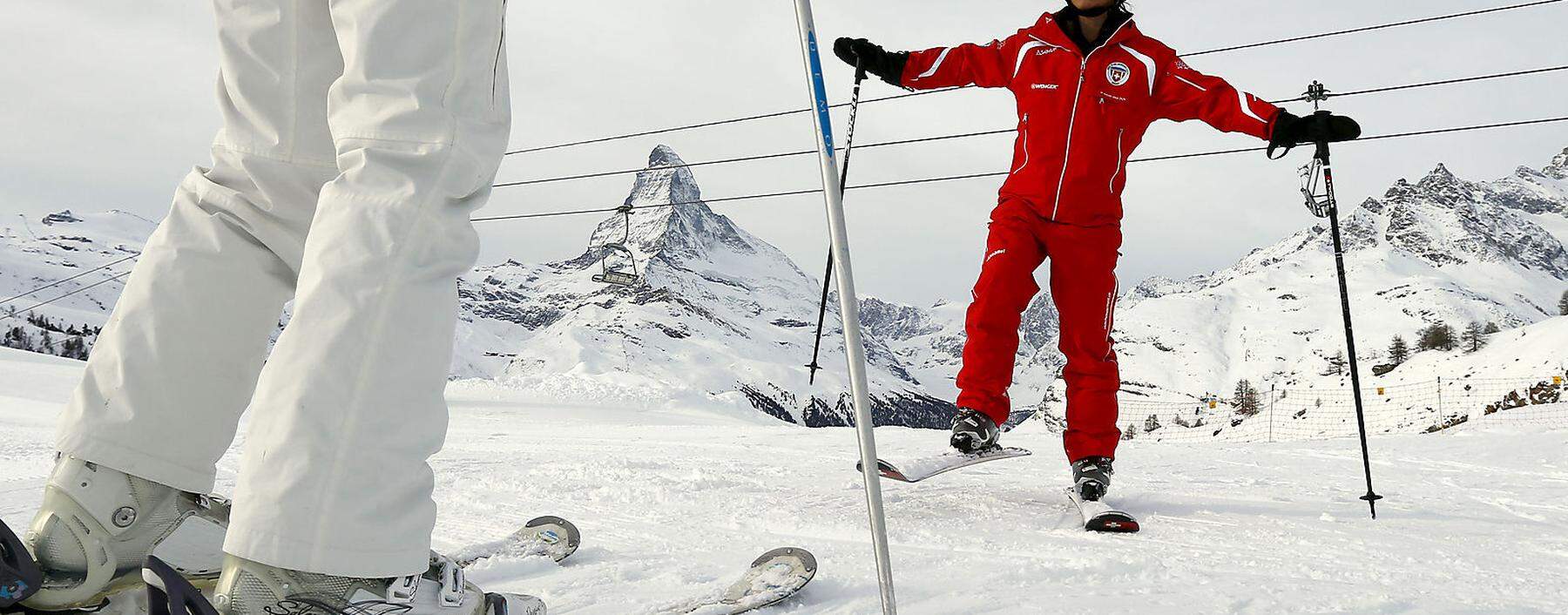 Chinese ski instructor Li exercises with a client during a private beginner ski course in the alpine resort of Zermatt