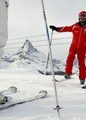 Chinese ski instructor Li exercises with a client during a private beginner ski course in the alpine resort of Zermatt