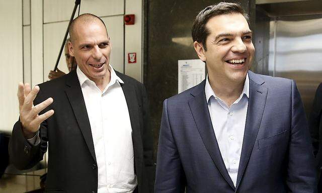 Greek Finance Minister Varoufakis welcomes PM Tsipras for a meeting at the ministry in Athens