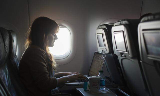 A woman uses her laptop to test a new high speed inflight Internet service named Fli-Fi while on a special JetBlue media flight out of John F. Kennedy International Airport in New York