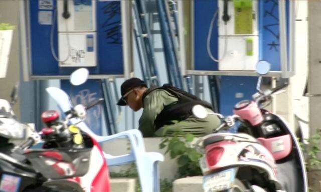 Explosive Ordnance Disposal (EOD) official checks at the scene of a bomb blast in Hua Hin