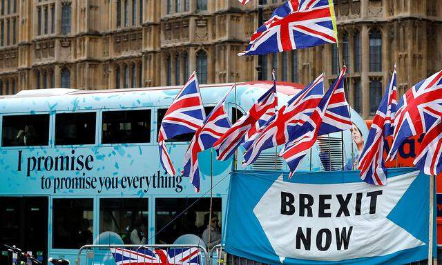 FILE PHOTO: A passenger bus passes a pro-Brexit demonstration in Westminster, London