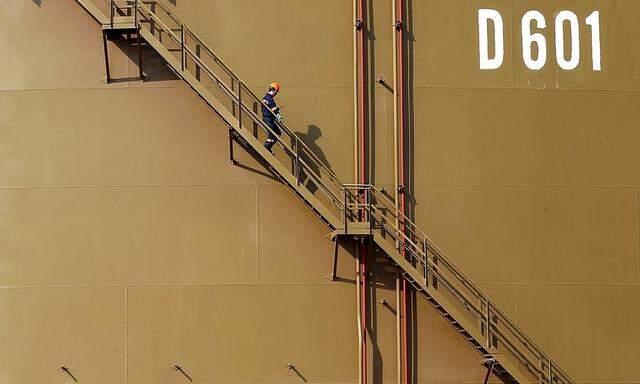 File photo of a worker walking down the stairs of an oil tank at Turkey's Mediterranean port of Ceyhan
