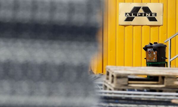 The logo of Austrian construction company Alpine is pictured on containers at a construction site on the A12 highway in the western Austrian city of Hall