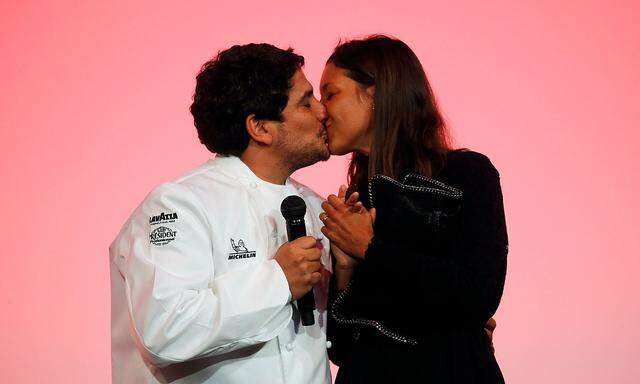 Newly awarded three-star Michelin Chef Mauro Colagreco, for his restaurant Mirazur in Menton, kisses his wife on stage  during the Michelin Guide 2019 award ceremony in Paris