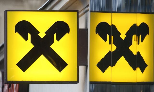 The logo of Raiffeisen Bank International is reflected in the glass of a branch office in Vienna