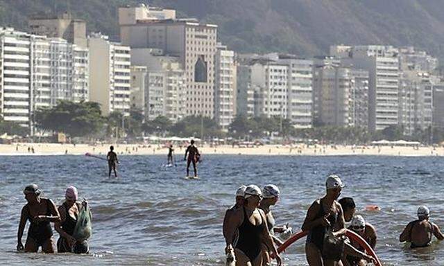 Residents collect garbage on Copacabana beach in Rio de Janeiro