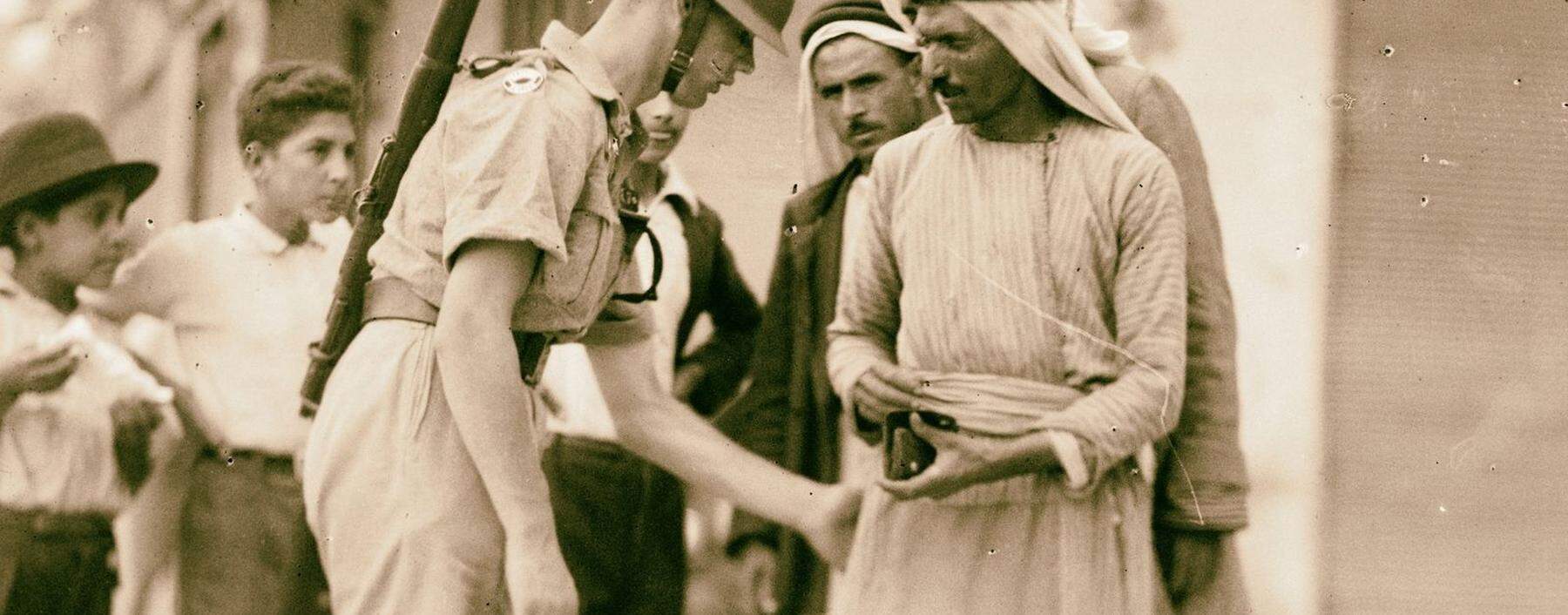 Ein britischer Soldat bei einer Durchsuchung arabischer Zivilisten in Palästina. 1936 begann eine Revolte der Araber gegen die Mandatsmacht.