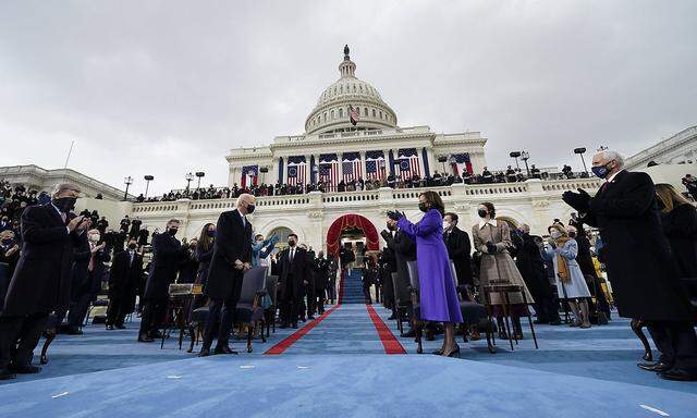Vice President-elect Kamala Harris, right, applauds as President-elect Joe Biden arrives at the U.S. Capitol for the in
