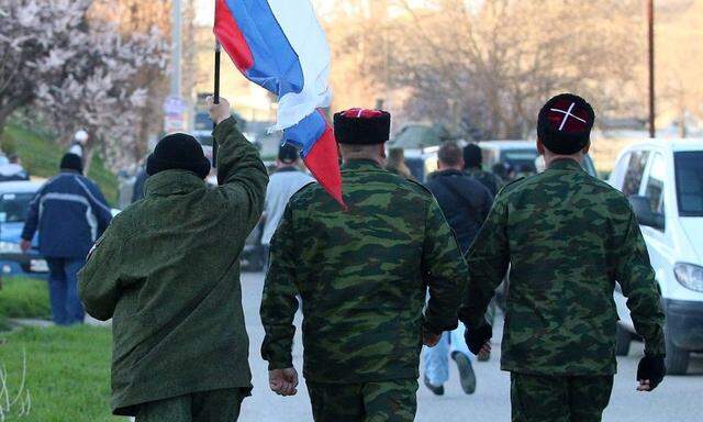 ITAR TASS SEVASTOPOL CRIMEA RUSSIA MARCH 23 2014 Men of Crimean self defense squads walk with