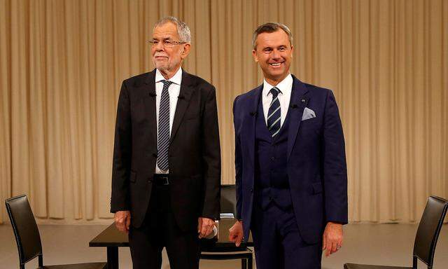 Austrian presidential candidate Van der Bellen, who is supported by the Greens, and Hofer of the FPOe pose for photographers before a TV discussion in Vienna