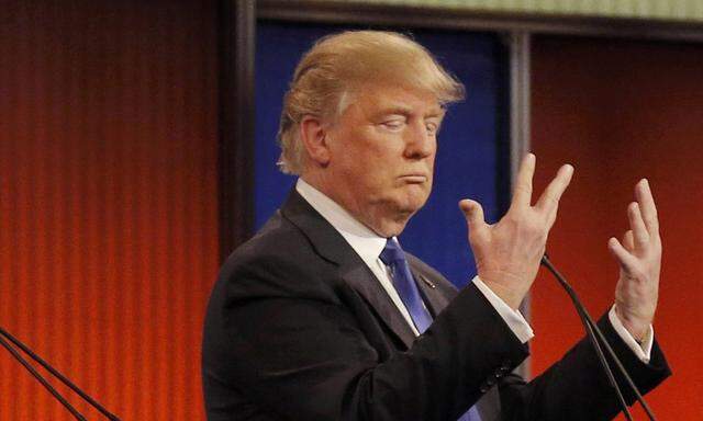 Republican U.S. presidential candidate Trump shows off the size of his hands as rivals Rubio and Cruz look on at the start of the U.S. Republican presidential candidates debate in Detroit