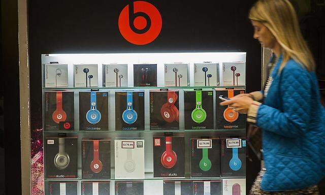 A pedestrian walks past a Beats brand display in the subway system of New York