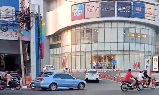 A person runs away from a shopping mall during a shooting rampage in Nakhon Ratchasima