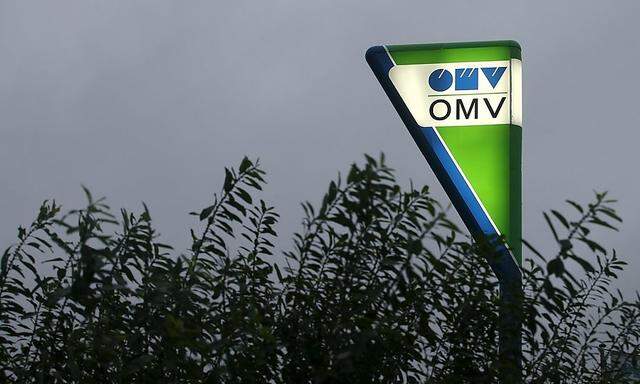 File photo of a sign post with the logo of Austrian Energy group OMV illuminated at a gas station in Vienna