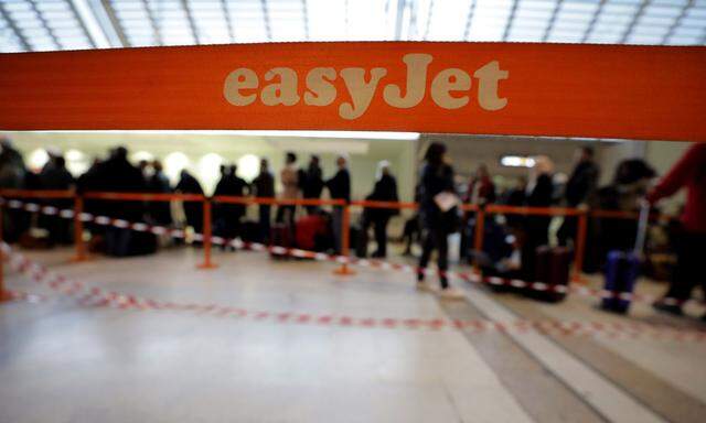Easyjet passengers line up at Nice Cote d'Azur airport as most of the flights are cancelled due to a storm in Nice