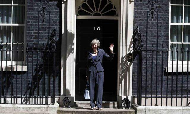 Britain´s Home Secretary Theresa May, who is due to take over as prime minister on Wednesday, waves as she leaves after a cabinet meeting at number 10 Downing Street, in central London, Britain