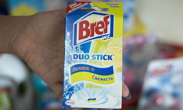 An employee shows a toilet freshener in the office of German consumer goods company Henkel in Kiev