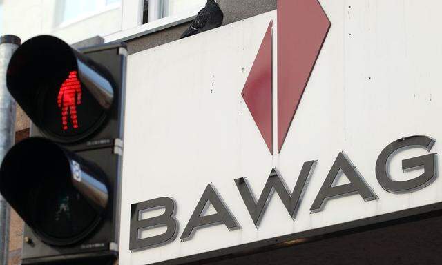 A pigeon sits atop the logo of Austrian lender BAWAG PSK next to traffic lights at a branch office in Vienna