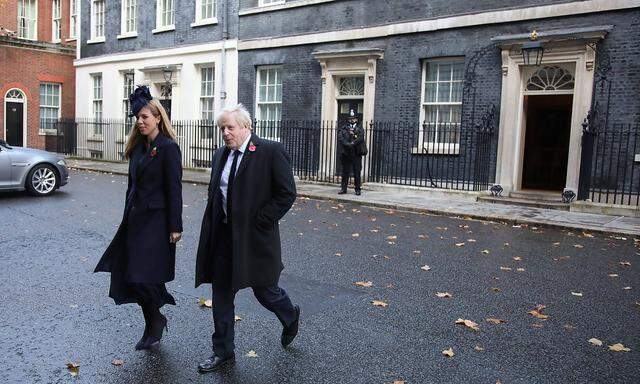 Prime Minister Boris Johnson and partner Carrie Symonds leave Number 10 Downing Street on the way to the Remembrance Su