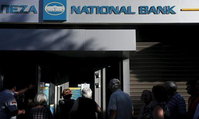 People line up outside a National Bank branch in Athens