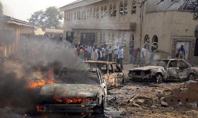 File photo shows a car burning at the scene of a Boko Haram bomb explosion at St. Theresa Catholic Church in Madalla, Nigeria