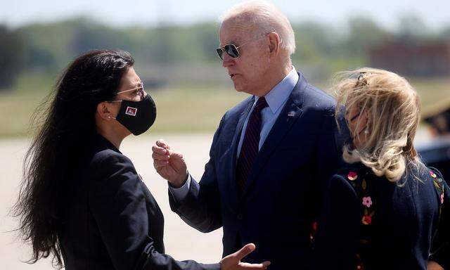U.S. President Joe Biden is greeted by U.S. Rep. Debbie Dingell (D-MI) and U.S. Rep. Rashida Tlaib at Detroit Metropolitan Wayne County Airport