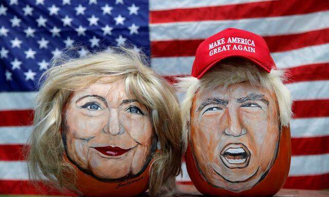 The images of U.S. Democratic presidential candidate Hillary Clinton and Republican Presidential candidate Donald Trump are seen painted on decorative pumpkins created by artist John Kettman in LaSalle