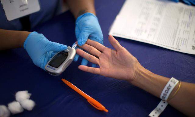 A person receives a test for diabetes during Care Harbor LA free medical clinic in Los Angeles