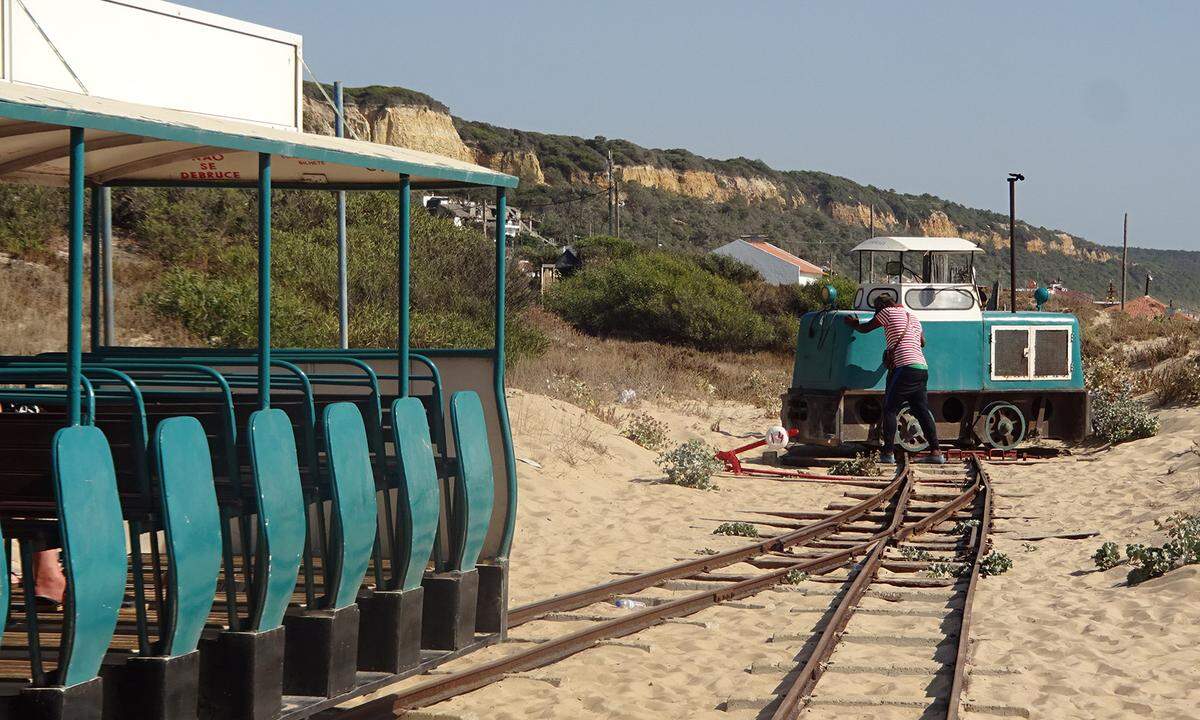 Der populärste Stadtstrand ist jedoch die viel besungene Costa da Caparica, per Taxi über die Brücke „25 de Abril“ um ca. 25 Euro erreichbar. Durch die Naturdünenlandschaft hinter dem Strand mit seinen beträchtlich hohen Wellen (und untergründigen Strömungen) kreuzt ein Liliputzug, der 12 Kilometer weit fährt, ehe die Loks händisch umgedreht werden. Viele Strandlokale auf dem Weg ...