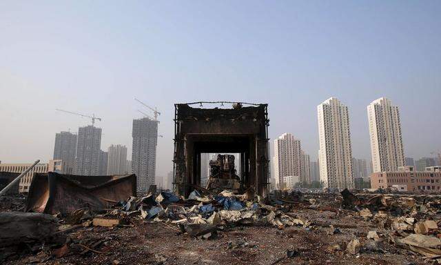 A damaged building is seen among debris at the site of Wednesday night's explosions in Binhai new district of Tianjin