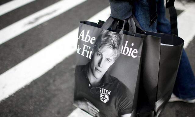 File photo of a man holding shopping bags while waiting to cross a street in New York  