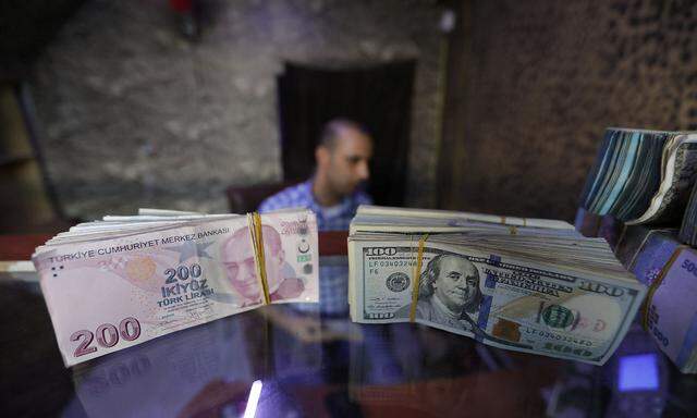 Banknotes of U.S. dollars and Turkish lira are seen in a currency exchange shop in the city of Azaz