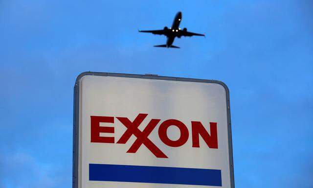 An airplane comes in for a landing above an Exxon sign at a gas station in the Chicago suburb of Norridge