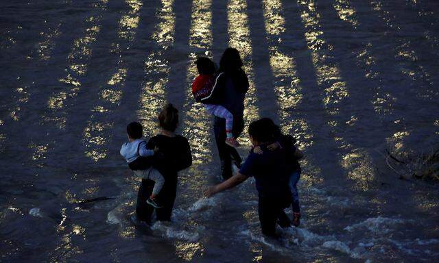 Migrants from Central America cross the Rio Bravo river to enter illegally into the United States as seen from Ciudad Juarez