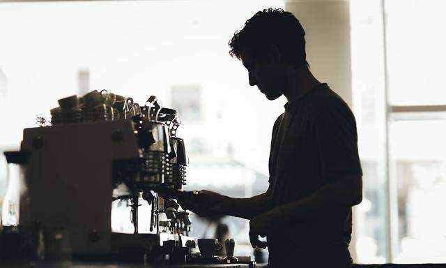 Silhouette of Barista preparing coffee in a coffee bar model released Symbolfoto property released P