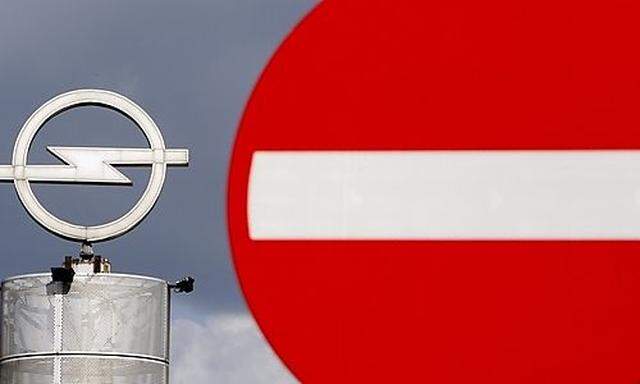 FILE - In this Thursday Sept. 10, 2009 file photo an Opel logo is seen next to a traffic sign outside