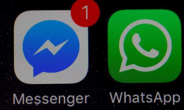 FILE PHOTO: WhatsApp and Facebook messenger icons are seen on an iPhone in Manchester , Britain.
