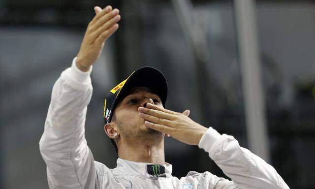 Mercedes Formula One driver Lewis Hamilton of Britain celebrates on the podium after winning the Abu Dhabi F1 Grand Prix at the Yas Marina circuit in Abu Dhab